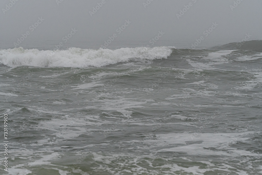 Atlantic Ocean waves breaking onto the beach at Belmar on a Misty Fog Morning on the New Jersey Shore