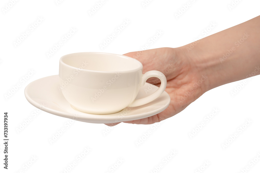 Female hand holding coffee cup and saucer isolated on white background. Female hand holding coffee cup and saucer isolated on white background.