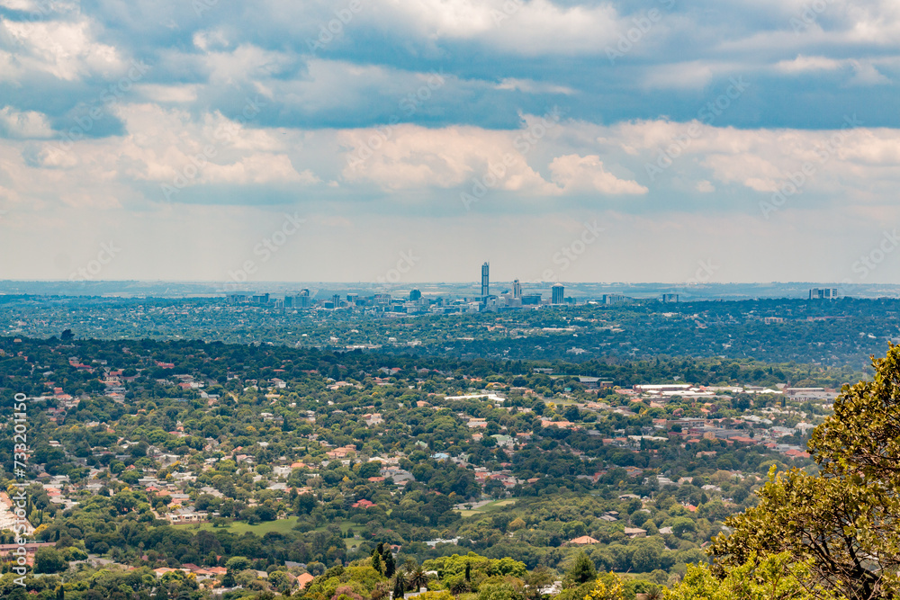 Fototapeta premium Elevated Panoramic view of Johannesburg - Northern View with Sandton centre of horizon from Northcliff with white soft clouds 