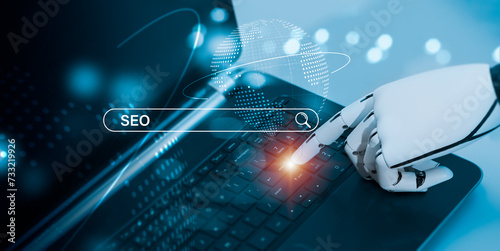 The robot's hand signals that you should push the enter key on the laptop's keyboard. The idea behind SEO, or search engine optimization, is to optimize your website using artificial intelligence. photo