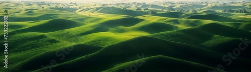Aerial view of green fields, rolling hills, and rural environment, pure nature, pristine nature scenery, untouched wilderness, website header, copy space. Generative AI ©  DigitalMerchant