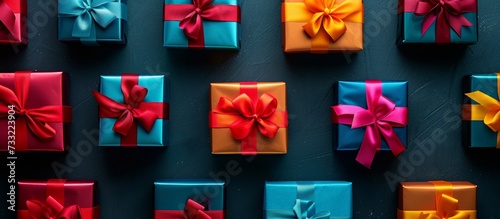 Banner with many gift boxes tied velvet ribbons and paper decorations on turquoise background. 