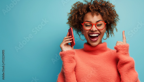 An African American woman, excited beyond herself with joy, is talking on the phone rejoicing at the good news