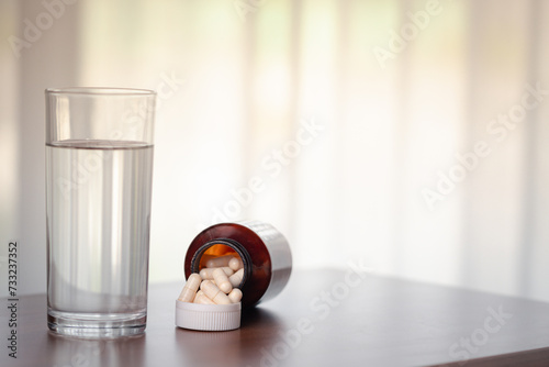 Pills and glass of water on...
