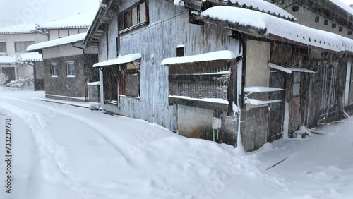 Walking by snow-covered houses of traditional village in Kyoto, Japan