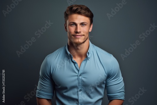 A man wearing a blue shirt strikes a pose while posing for a picture.