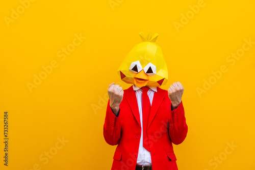 Cool man wearing colorful stylish suit with 3d origami animal funny mask on isolated colored background