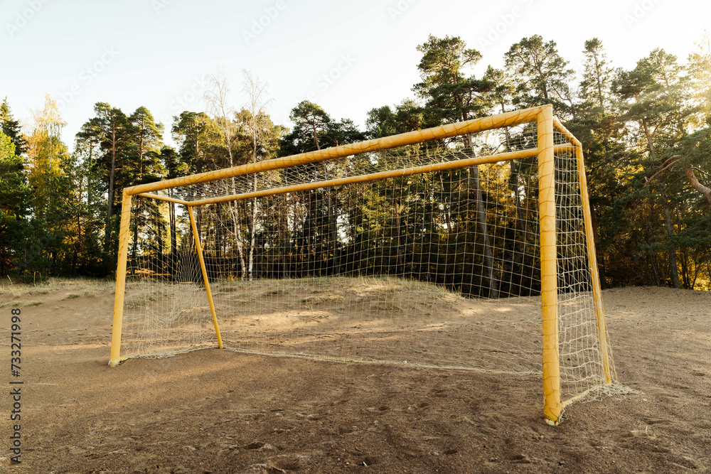 soccer goal on a sandy beach near the sea