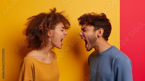 Studio shot of couple yelling at each other isolated on yellow background, Domestic issue, Marriage problem, relationship break issue