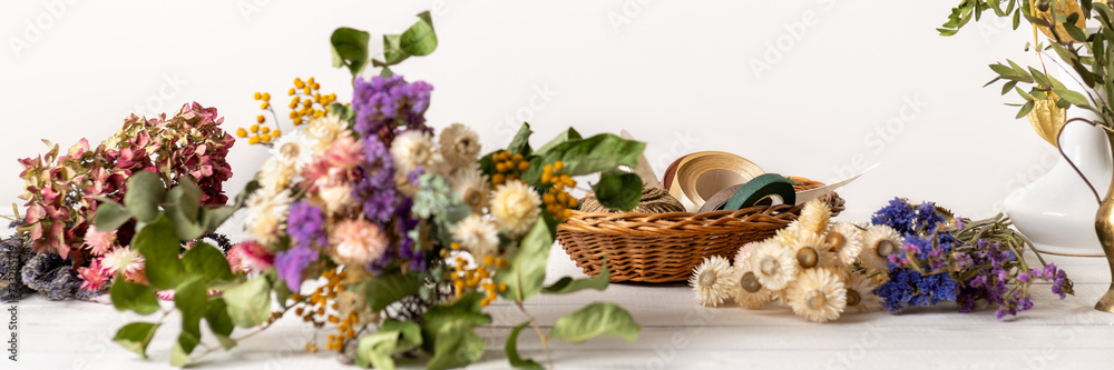 Dried flowers banner. Arranging dried flowers into a beautiful bouquet. Sustainable floristry. Creating home decor with dried flowers.