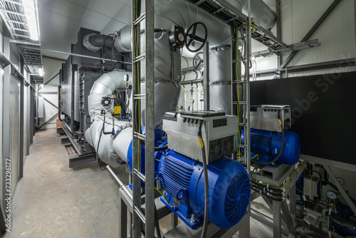 Lithium bromide absorption heat pump and modern water pumps with SynRM type electric motors in a power plant