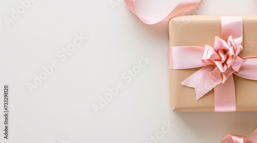 Gift box with pink ribbon on soft white background, a symbol of love and appreciation for Mother's Day, promoting emotional well-being and care, expressing gratitude and emotional connection