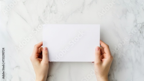 A top-down perspective of a school workspace with hands holdin a blank white paper, mental health and wellness, promoting focus and positivity in education, Workspace setup for learning and creativity