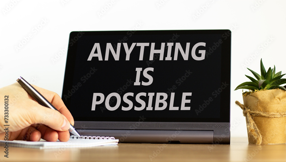 Anything is possible symbol. Concept words Anything is possible on beautiful tablet screen. Beautiful wooden table white background. Businessman hand. Business anything possible concept. Copy space. Anything is possible symbol. Concept words Anything is possible on beautiful tablet screen. Beautiful wooden table white background. Businessman hand. Business anything possible concept. Copy space.