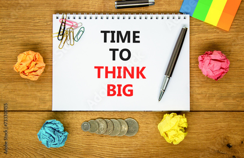 Time to think big symbol. Concept words Time to think big on beautiful white note. Beautiful wooden table background. Colored paper. Black pen. Business and time to think big concept. Copy space.