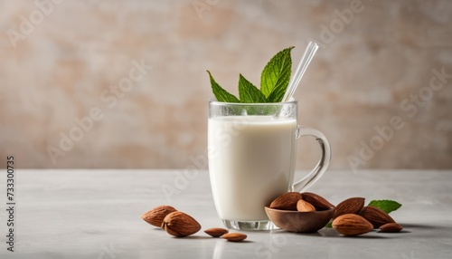 A glass of milk with a spoon and almonds