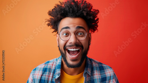 African-american man makes a huge happy face, short hair and glasses, lively facial expressions © Ratthamond