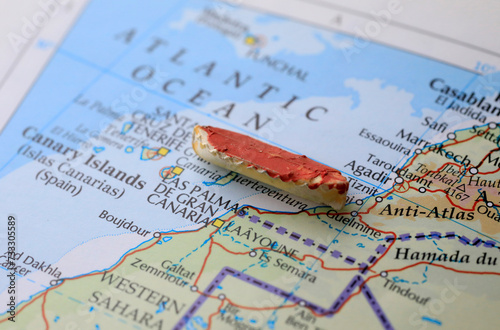 A boat and a map of Africa representing the immigration over sea