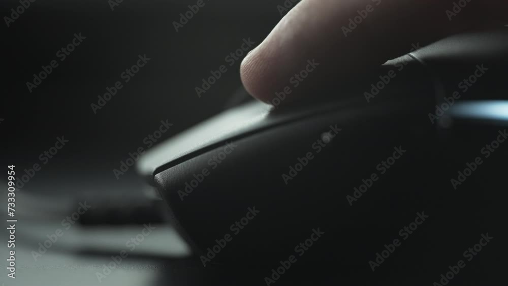 Clicking black computer mouse on a work desk. Close up. 