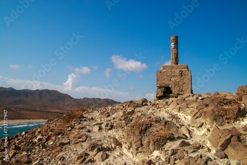 Punto geodésico sobre la colina conocida como Cerro de Los Genoveses, en San José, Almería, España. Vista del paisaje costero y desértico a orillas del mar Mediterráneo. photo