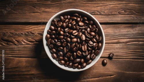 A bowl full of coffee beans on a wooden table photo