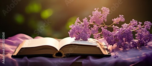 branch of lilac the hat and book on a wooden table © Fatima