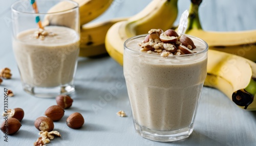 Two glasses of milkshake with nuts on top