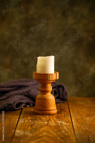 A wooden table with a candle.
Image of a pleasant atmosphere.
