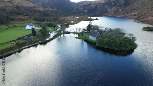 Timeless tranquility in Gougane Barra, County Cork, Ireland – where water flows gracefully around a historic chapel, capturing the essence of peaceful beauty