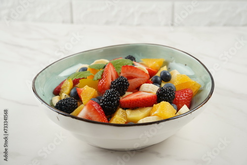 Summer Fruit salad with oranges  strawberries  blueberries  blackberries and fresh mint. Healthy food