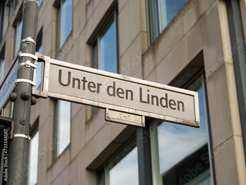 Unter den Linden street in Berlin. Sign with the road name at an intersection. The location is popular as boulevard in the capital city of Germany. It is named after the linden trees. © Felix Geringswald