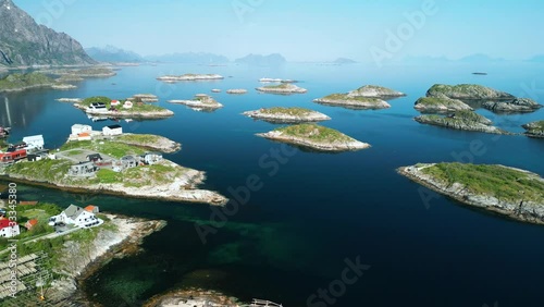 Henningsvaer Stadium in Lofoten Islands, Norway. The drone flies smoothly back showing a panorama of the sea with small islands and the famous football stadium photo