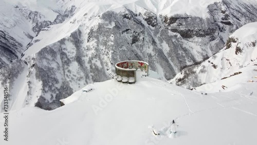Gudauri, Georgia - December 26, 2021: Aerial view of Russia-Georgia Friendship Monument located on the Georgian Military Highway in the Caucasus.
