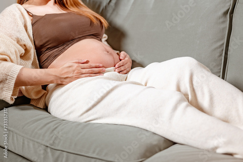 mother, family, maternity, pregnant, woman, pregnancy, baby, motherhood, love, happiness. pregnancy, close up of happy pregnant woman and waiting for her little baby birth. sit on sofa and smiling.