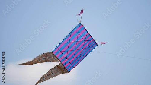 Colorful kite floating on sky photo