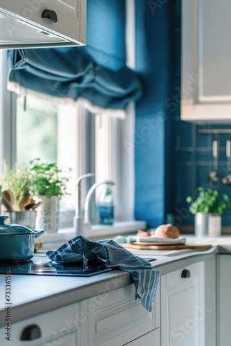 A kitchen with blue walls and white cabinets. Perfect for home renovation or interior design projects