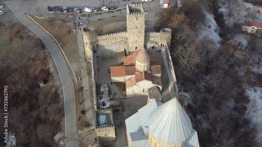 Aerial view of Ananuri Fortress Complex in Georgia. Ananuri fortress at the Zhinvali reservoir against the background of mountains. Aerial view of Ananuri Fortress Complex in Georgia. Ananuri fortress at the Zhinvali reservoir against the background of mountains.