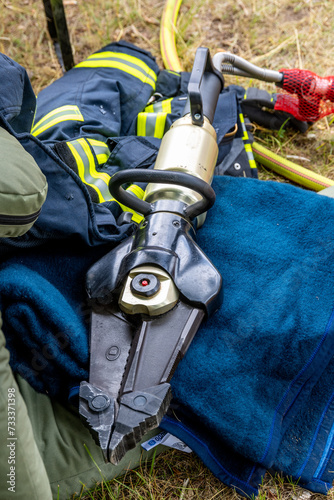 Firefighter Hydraulic Rescue Tool Resting on Gear photo