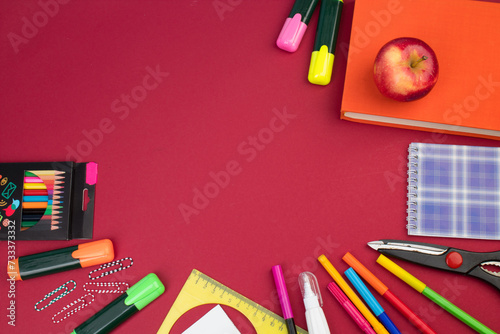 Back to school. Stationery on a Burgundy table. Office desk with copy space. Flat lay.