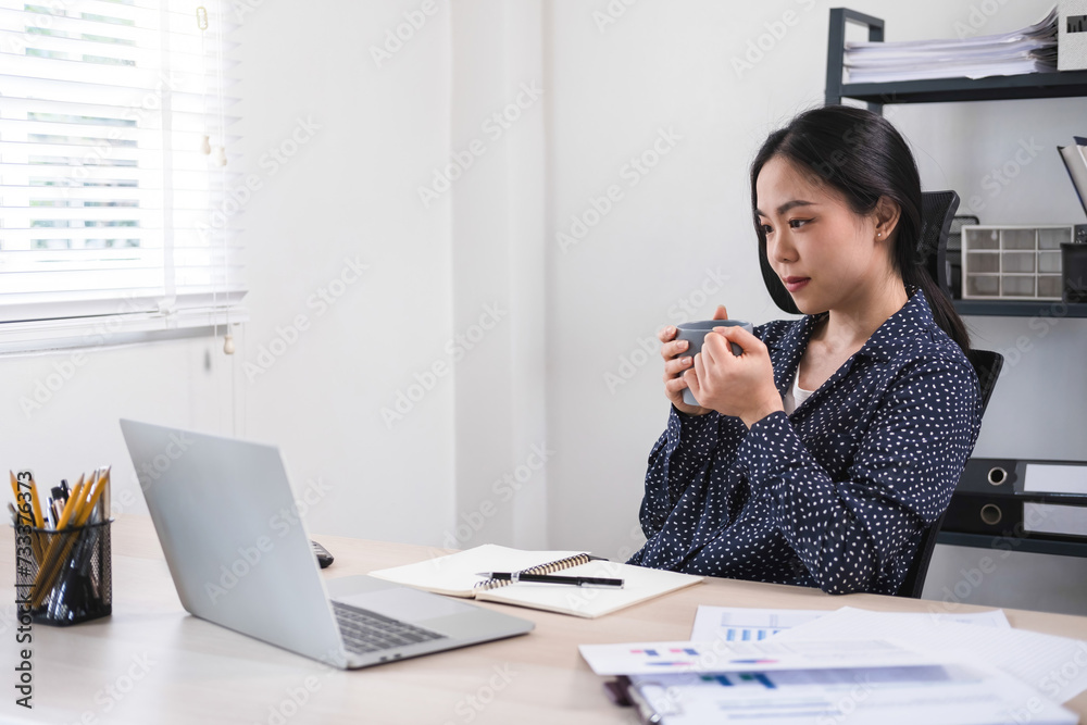 Businesswoman working while enjoying coffee. Businesswoman working while enjoying coffee.