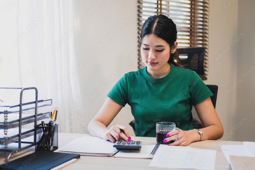 Woman working by using calculator. Woman working by using calculator.