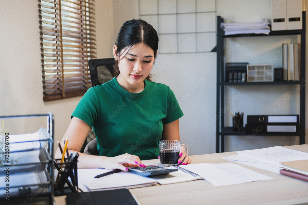 Woman working by using calculator. Woman working by using calculator.