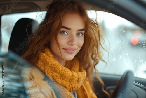 A girl with long hair gazes at her reflection in the car mirror, lost in thought as she drives through the vast outdoor landscape, her clothing billowing in the wind