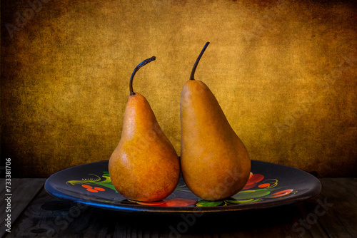 Wallpaper Mural still life of two pears on a plate with a textured background Torontodigital.ca