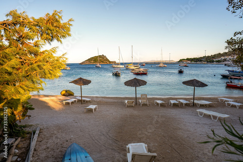 Obraz na płótnie Panorama shot of motor boats parked at a dock named Agios Nikolaos harbour against blue sea and mountain in one of the ionian island of Zakynthos, Greece w salonie
