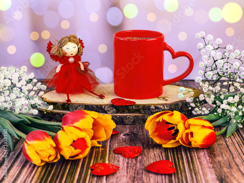 Red cup of coffee with heart  fairy doll  bouquet of tulips and gypsophila with bokeh effect. Happy Valentine s Day greeting card