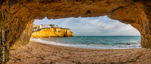 View of Carvoeiro beach from one of its cliff caves, Lagoa, Algarve, Portugal, Picturesque fishing village with gorgeous sandy beaches protected by cliffs. photo