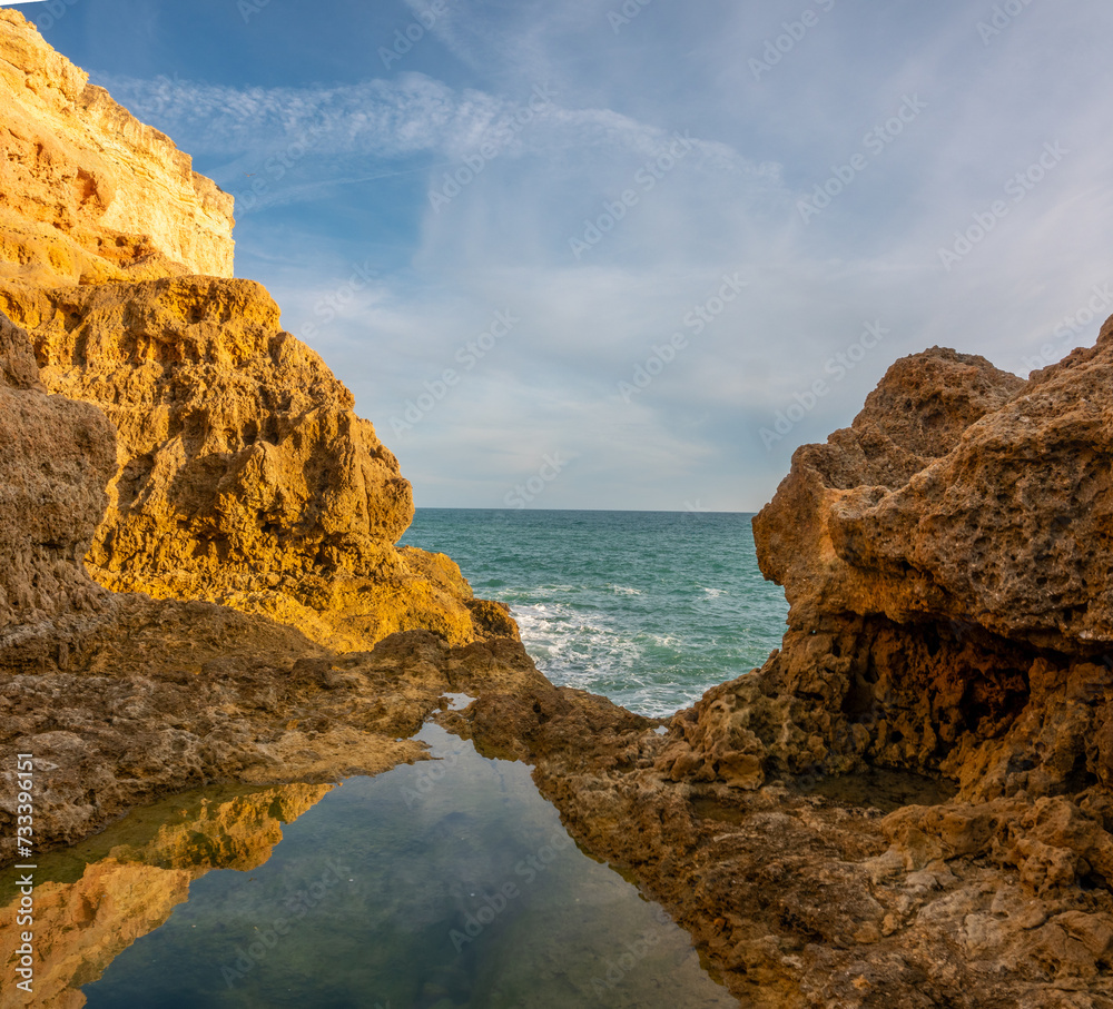 Fototapeta premium Natural infinite pool, Algar seco cliffs, Carvoeiro, Lagoa, Algarve, Portugal. Stunning limestone rock formations in the Algarve coast of Portugal