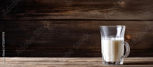 a glass of white milk on a wooden table