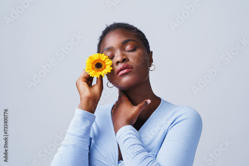 Woman with yellow flowers shows emotions. photo